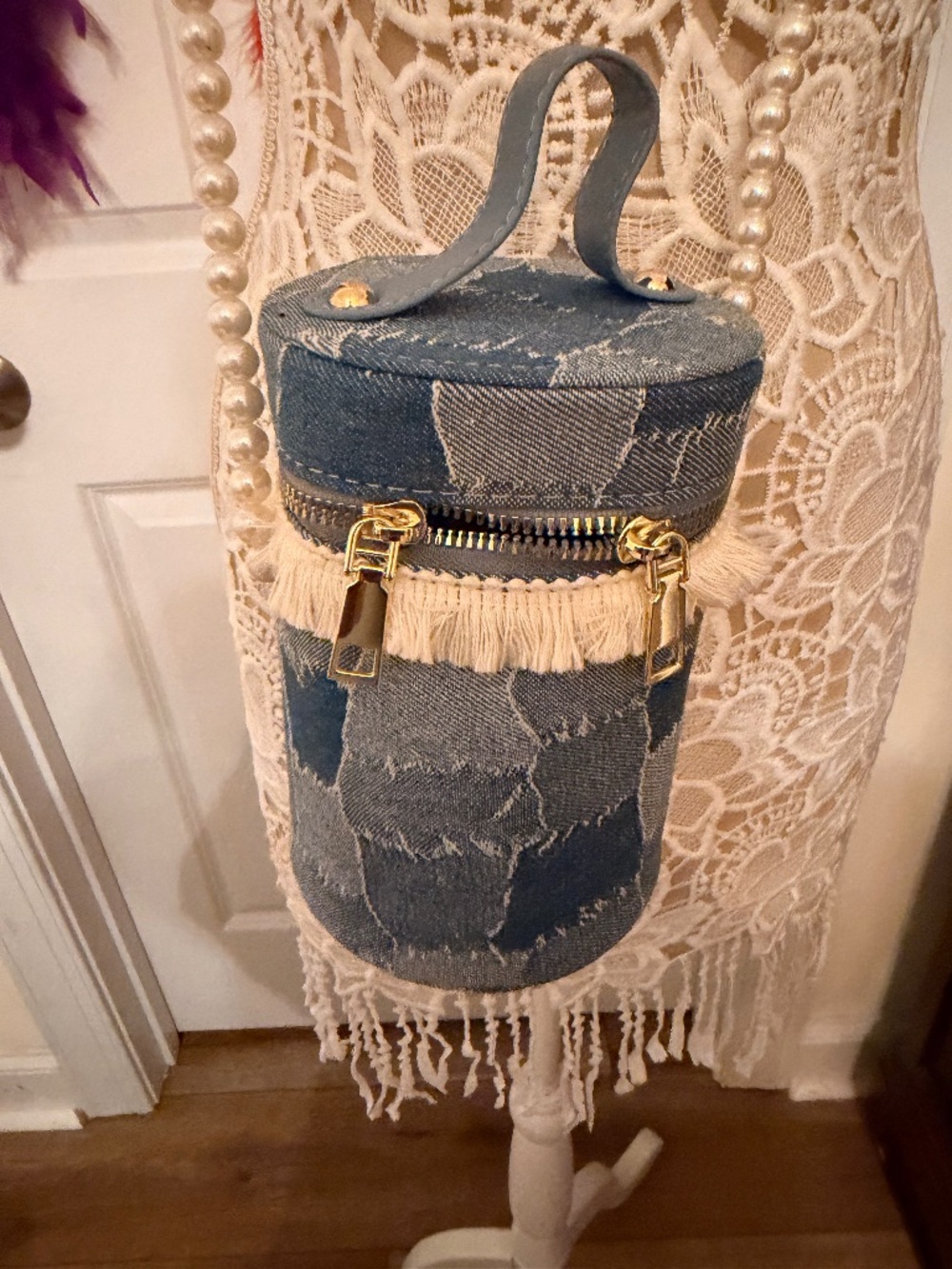 Cylindrical patchwork denim bag.